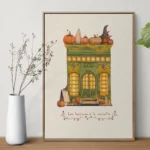 Illustration automnale d'une petite librairie-café verte décorée de citrouilles, guirlandes lumineuses et feuillages.